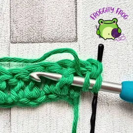 Starting the front post puff stitch of the Fondant stitch